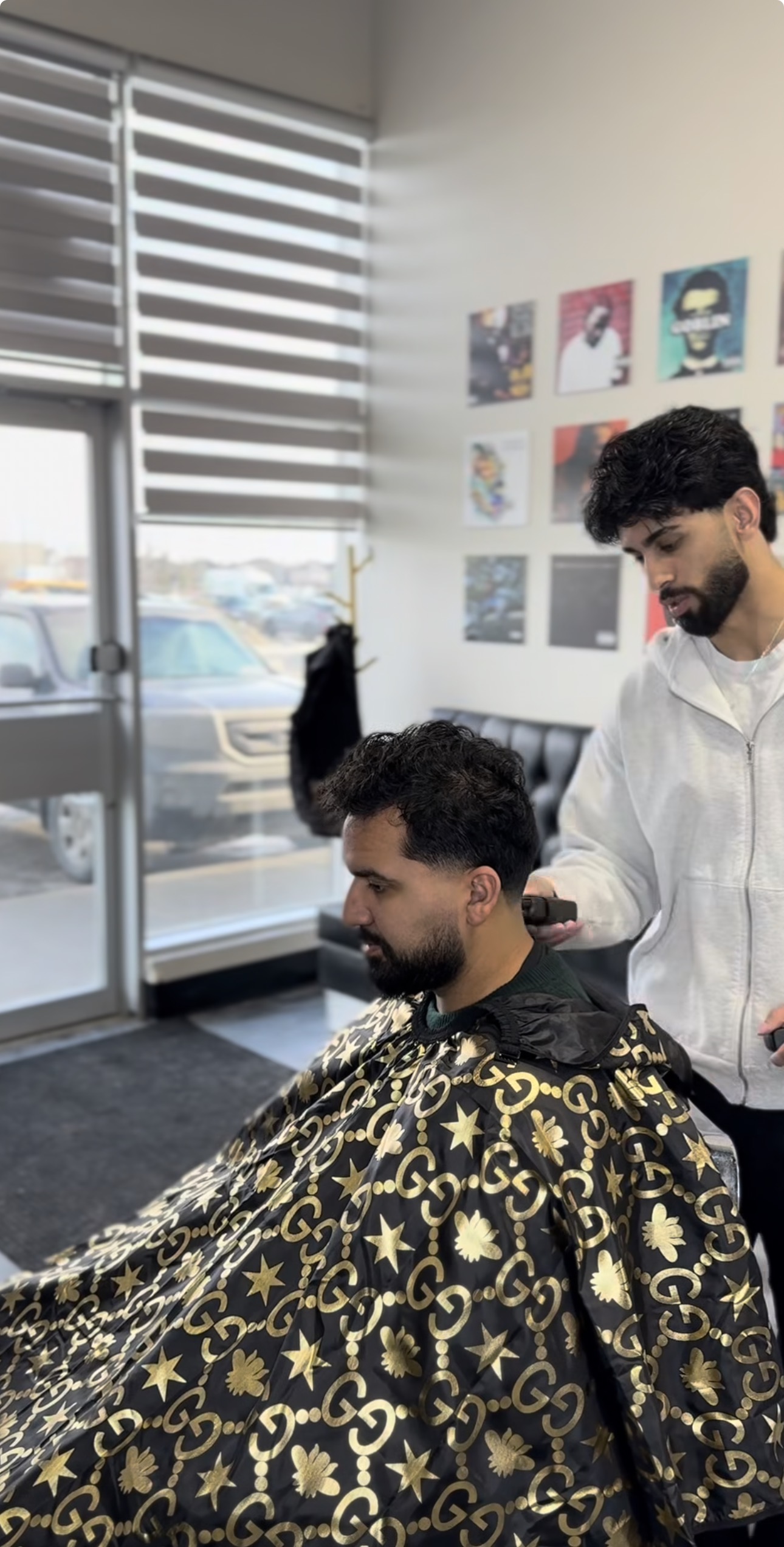 Haris cutting hair at Barber and Sons